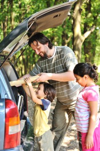 Family with car in nature